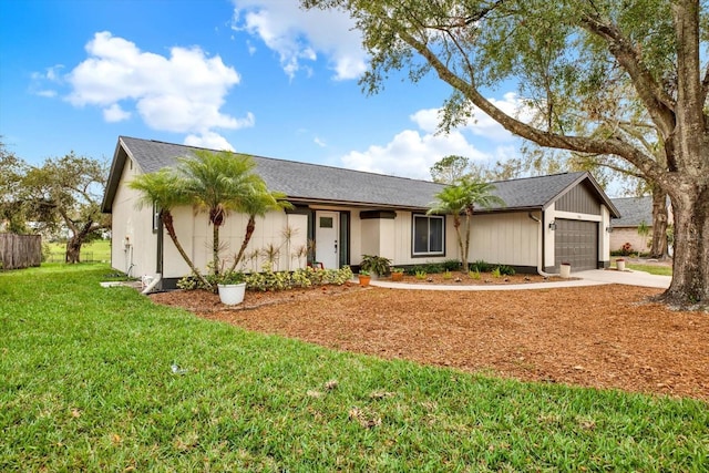 ranch-style home featuring a garage, concrete driveway, and a front lawn