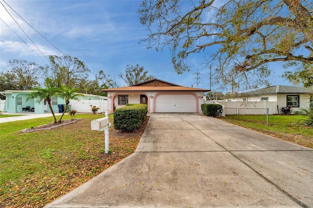 single story home featuring driveway, an attached garage, fence, a front lawn, and stucco siding