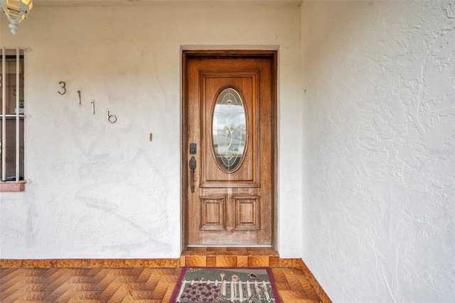 property entrance with stucco siding