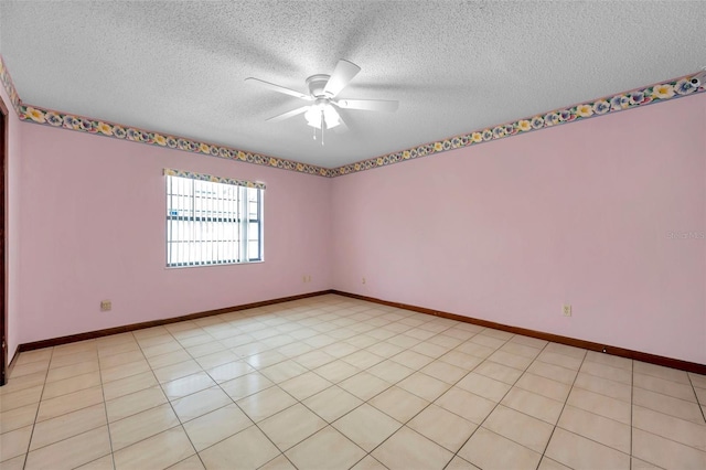 unfurnished room featuring a textured ceiling, ceiling fan, and baseboards