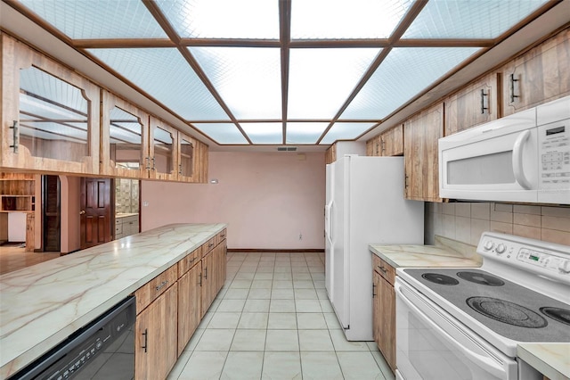 kitchen with light countertops, white appliances, and brown cabinets