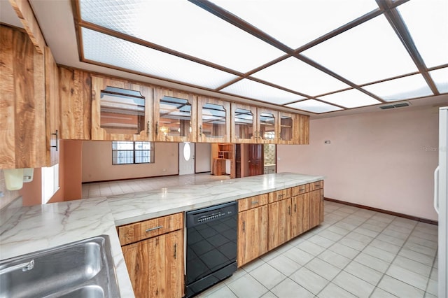 kitchen with black dishwasher, visible vents, brown cabinets, a peninsula, and a sink