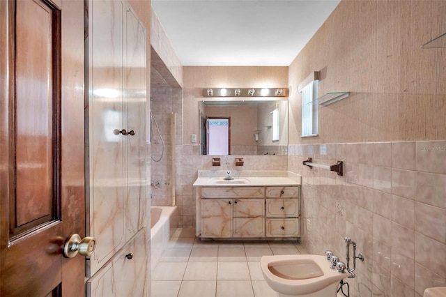 bathroom with tile walls, a bidet, vanity, shower / tub combination, and tile patterned floors