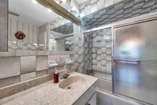 full bathroom with enclosed tub / shower combo, visible vents, backsplash, and vanity