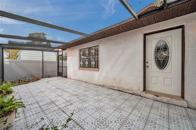 entrance to property with a patio area and stucco siding