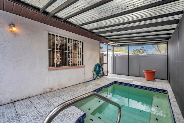 view of pool featuring a patio area, fence, and an in ground hot tub