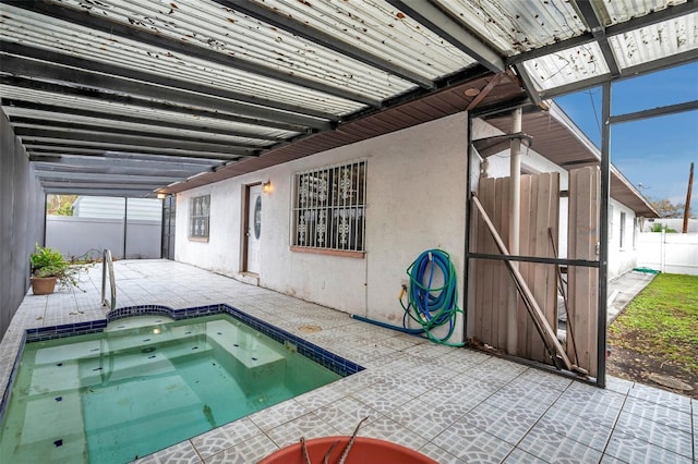 view of swimming pool with a patio area, fence, and a hot tub