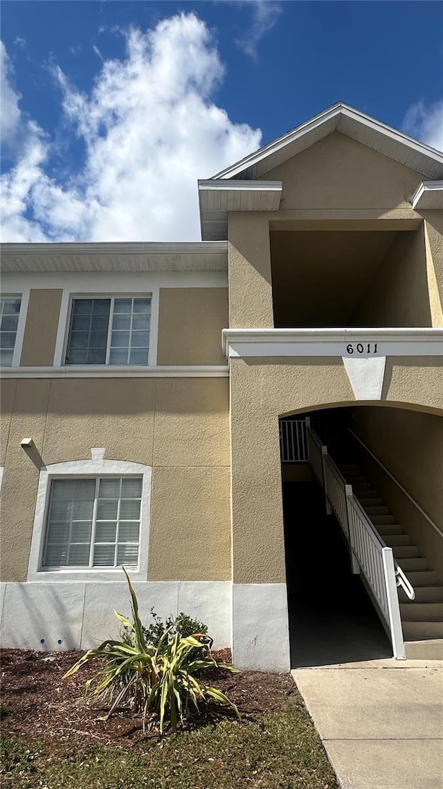 view of side of property with stucco siding