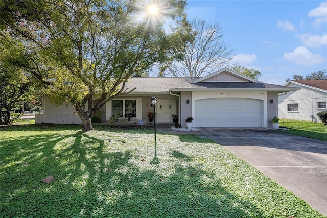 ranch-style home featuring an attached garage, driveway, a front yard, and brick siding