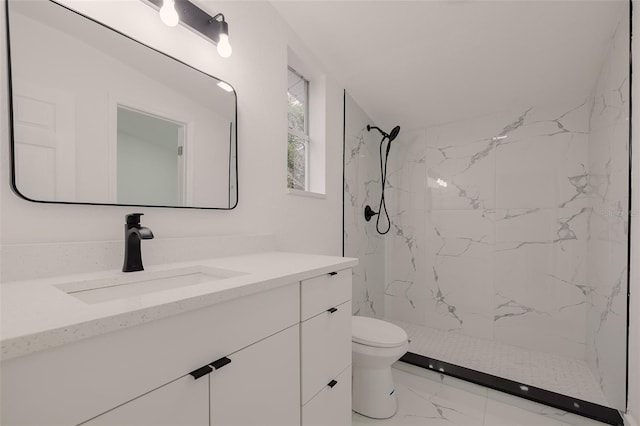 full bathroom with toilet, marble finish floor, a marble finish shower, and vanity