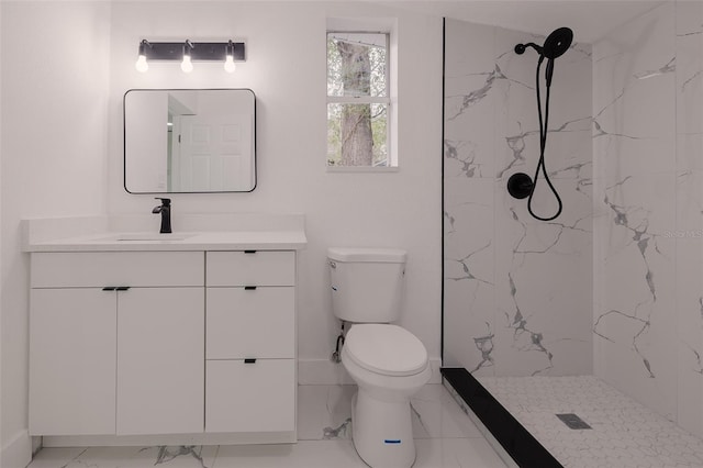 bathroom with toilet, marble finish floor, a marble finish shower, and vanity