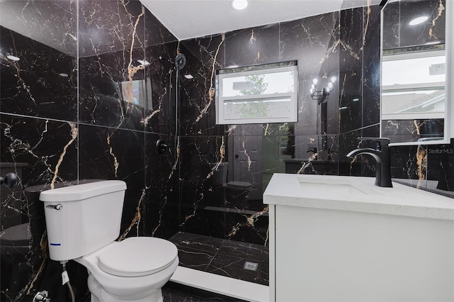 full bathroom featuring toilet, a marble finish shower, tile walls, and vanity