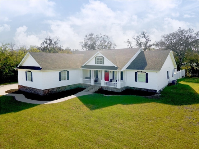 view of front of home featuring covered porch, central AC, and a front yard