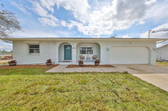 single story home featuring a garage, driveway, a front lawn, and stucco siding