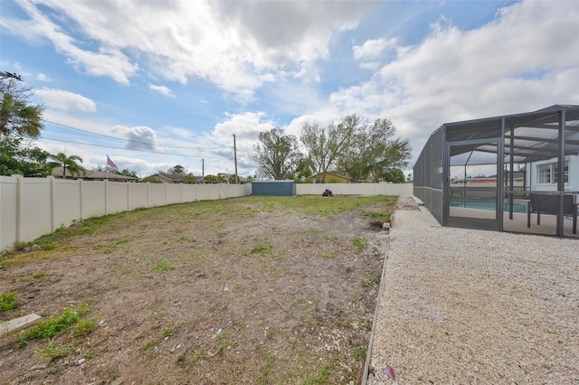 6333 Spanish Main Dr, Apollo Beach, FL 33572 - view of yard featuring glass enclosure, a fenced backyard, a fenced in pool, and a patio