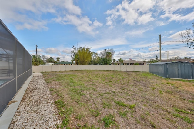 6333 Spanish Main Dr, Apollo Beach, FL 33572 - view of yard featuring a fenced backyard, an outdoor structure, and a storage unit