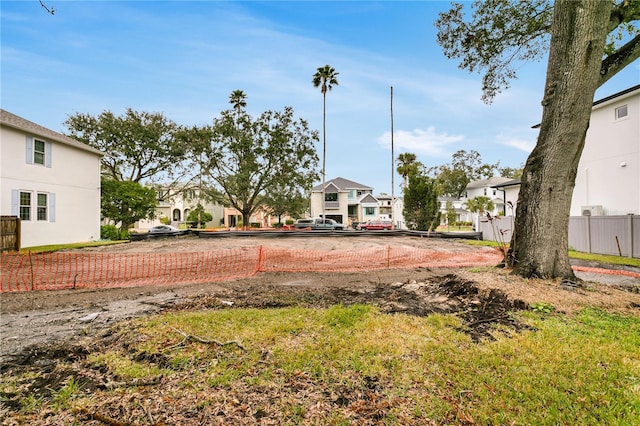 view of yard featuring a residential view and fence