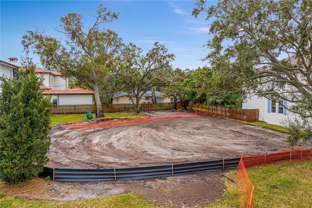 view of swimming pool featuring fence