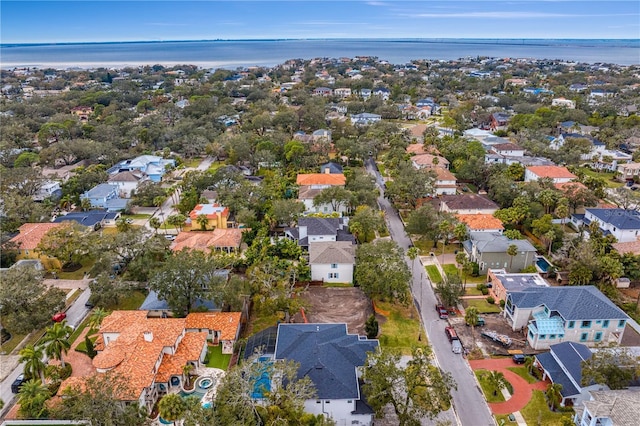 drone / aerial view featuring a residential view and a water view