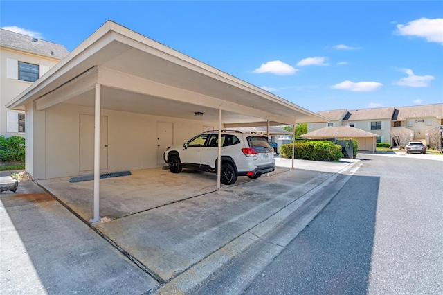 covered parking lot with a residential view