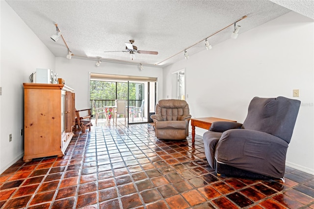 sitting room featuring track lighting, a ceiling fan, and a textured ceiling