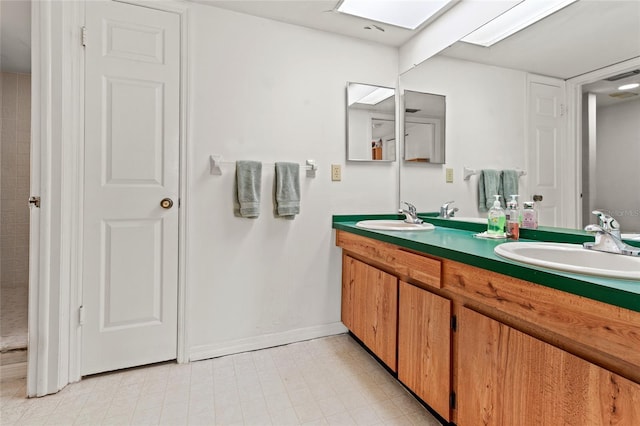 full bathroom with double vanity, a skylight, a closet, and a sink