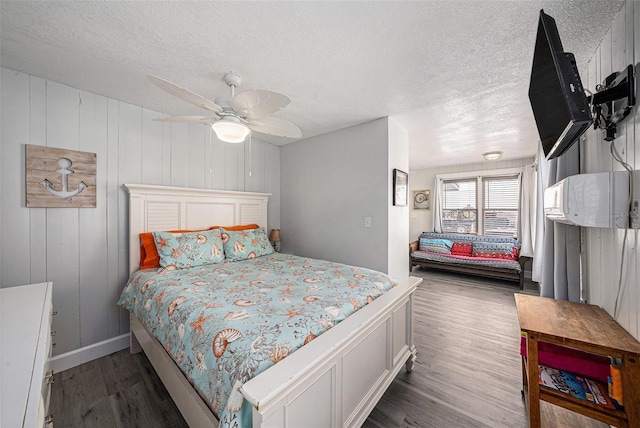 bedroom featuring ceiling fan, a textured ceiling, and wood finished floors