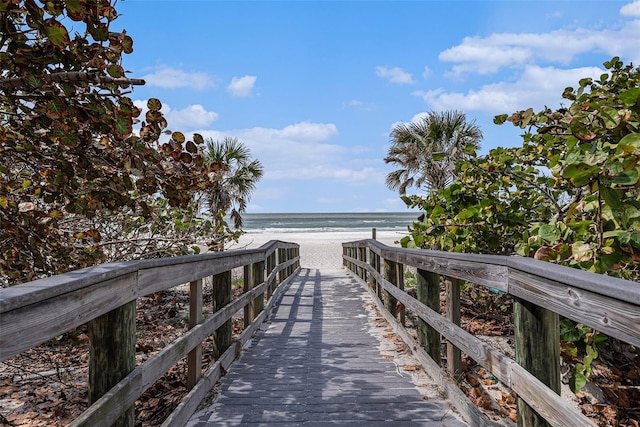 dock area featuring a water view and a view of the beach