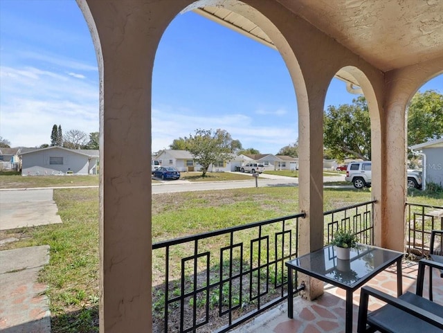 balcony featuring a residential view and covered porch