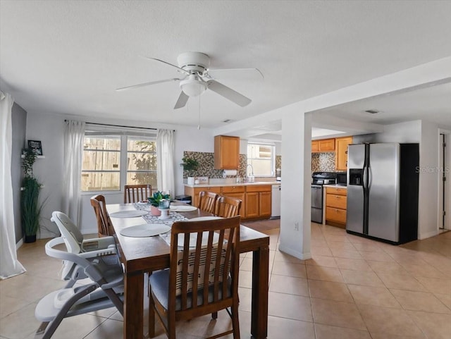 dining area featuring light tile patterned floors, ceiling fan, and visible vents