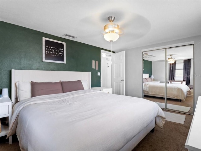 carpeted bedroom featuring visible vents and a ceiling fan