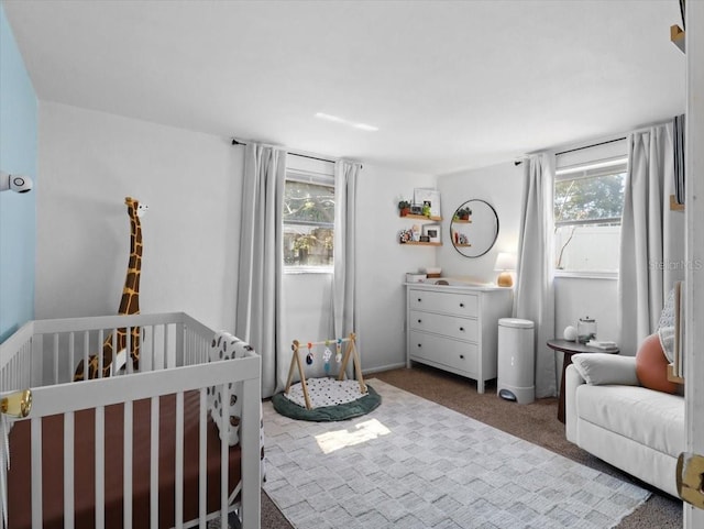 bedroom featuring a crib and carpet