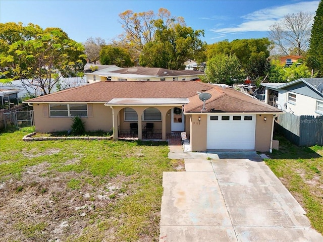 single story home featuring a garage, a front yard, fence, and stucco siding