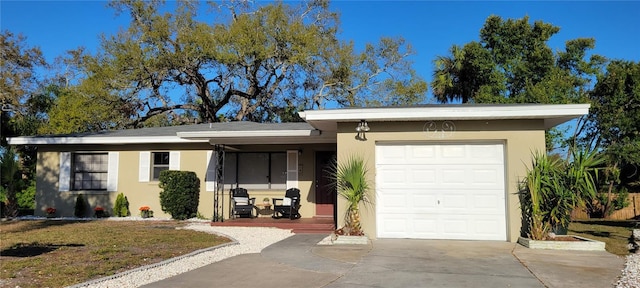 single story home featuring stucco siding, concrete driveway, and a garage