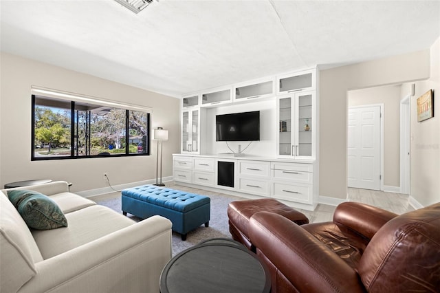 living area featuring visible vents and baseboards