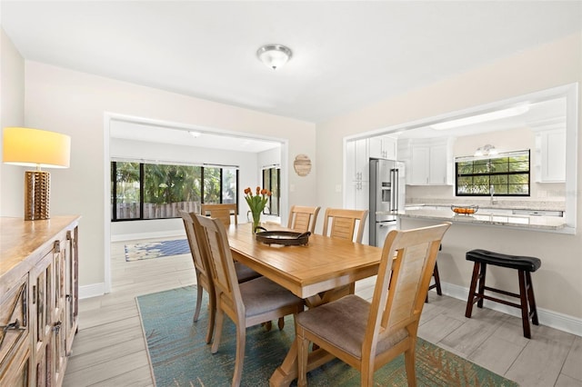 dining area featuring baseboards and wood finish floors