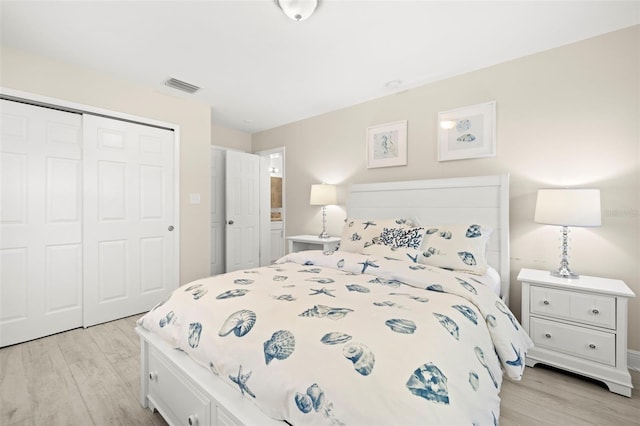 bedroom with visible vents, a closet, and light wood-style flooring