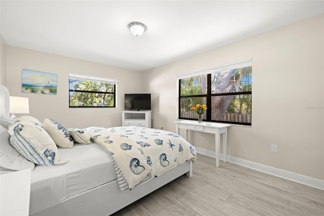 bedroom featuring light wood-type flooring and baseboards