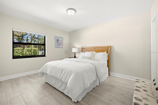 bedroom featuring light wood-type flooring and baseboards