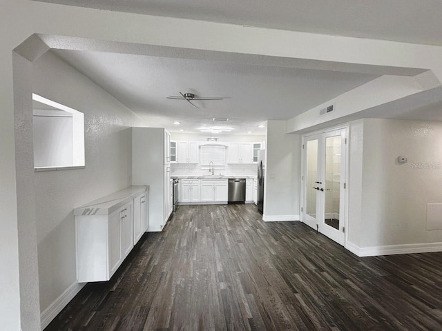 kitchen with glass insert cabinets, appliances with stainless steel finishes, dark wood finished floors, and a sink