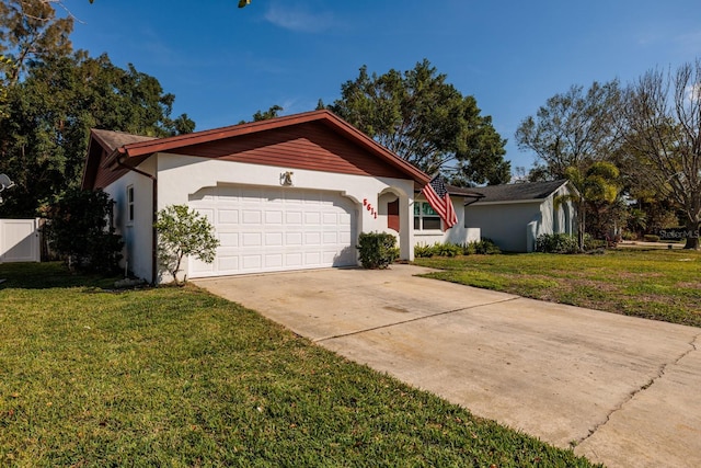 ranch-style house with a garage, a front yard, driveway, and stucco siding