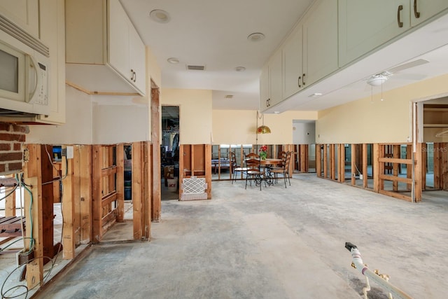 miscellaneous room featuring concrete flooring and visible vents