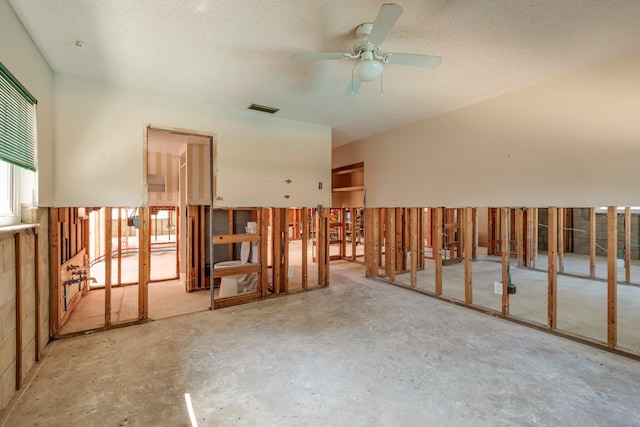 spare room featuring ceiling fan, visible vents, and a textured ceiling