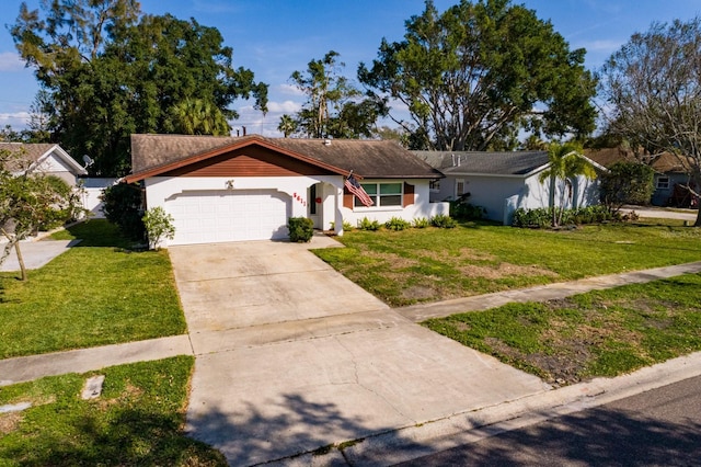 single story home featuring an attached garage, stucco siding, concrete driveway, and a front yard