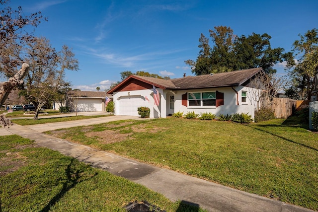 ranch-style home with a garage, fence, driveway, stucco siding, and a front yard