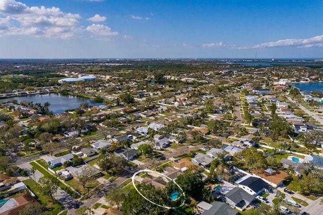 birds eye view of property with a residential view and a water view