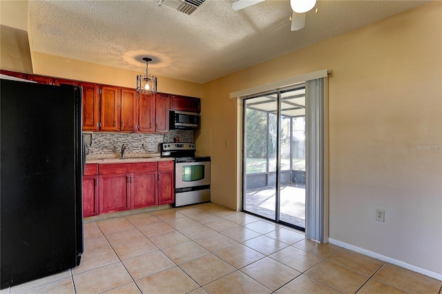 kitchen featuring pendant lighting, light countertops, visible vents, decorative backsplash, and black appliances