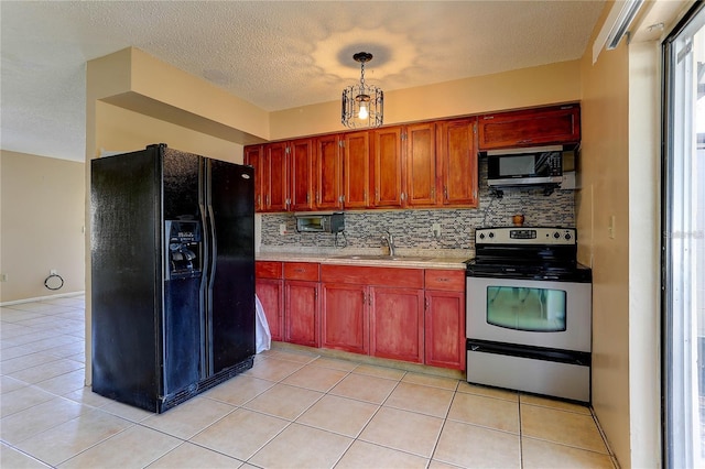 kitchen featuring light countertops, decorative backsplash, appliances with stainless steel finishes, light tile patterned flooring, and a sink