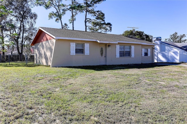 single story home featuring stucco siding, fence, and a front yard