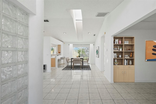 interior space featuring light tile patterned floors and visible vents